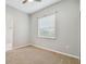 Simple bedroom with neutral walls, carpet, and window at 445 Hightower Dr, Debary, FL 32713