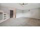 Large bonus room with built-in shelving and ceiling fan at 445 Hightower Dr, Debary, FL 32713