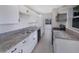 Bright kitchen with white cabinets and granite counters at 803 Plumosa Ave, Fruitland Park, FL 34731