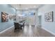 Bright dining room with glass table and gray chairs, hardwood floors, and large windows at 713 Silversmith Cir, Lake Mary, FL 32746