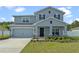 Two-story home with gray siding and landscaped yard at 340 Citrine Loop, Kissimmee, FL 34758