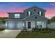 Two-story home with gray siding and landscaped yard at 340 Citrine Loop, Kissimmee, FL 34758