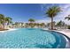 Stunning resort-style pool with palm trees and plenty of lounge chairs at 1676 Tropical Palms Cir, Kissimmee, FL 34747