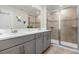 Modern bathroom with double vanity and large shower at 1676 Tropical Palms Cir, Kissimmee, FL 34747