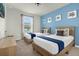 Bedroom with twin beds and coastal decor at 1676 Tropical Palms Cir, Kissimmee, FL 34747