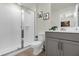 Clean bathroom with shower and grey vanity at 1676 Tropical Palms Cir, Kissimmee, FL 34747