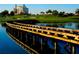 Wooden bridge over water with resort in background at 1535 Corolla Ct, Reunion, FL 34747