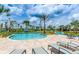 Relaxing pool area with lounge chairs and landscaping at 3150 Paradox Cir # 104, Kissimmee, FL 34746