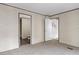 Simple bedroom with carpeting and a view of the bathroom at 18955 Se 107Th Pl, Ocklawaha, FL 32179