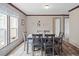 Simple dining room with gray table and chairs near a window at 18955 Se 107Th Pl, Ocklawaha, FL 32179