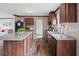 Modern kitchen with wooden cabinets, granite countertops, and a large island at 18955 Se 107Th Pl, Ocklawaha, FL 32179