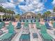 Community pool with lounge chairs and a hot tub at 2606 Lodi Cir # 105, Kissimmee, FL 34746
