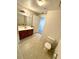 Bathroom with toilet, vanity, and mirror at 2606 Lodi Cir # 105, Kissimmee, FL 34746