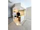 Small kitchen with wood cabinets, black appliances, and a breakfast bar at 2606 Lodi Cir # 105, Kissimmee, FL 34746