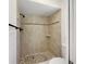 Beige tiled shower with a pebble stone shower floor at 509 Savona Ct, Altamonte Springs, FL 32701