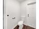 Small half bathroom with white toilet and dark brown floor at 509 Savona Ct, Altamonte Springs, FL 32701