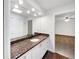 Bathroom boasts granite countertop, white cabinets, and a view of bedroom at 509 Savona Ct, Altamonte Springs, FL 32701