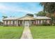 Community building with brick facade and landscaping at 1264 Village Way, Orlando, FL 32807