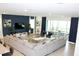 Open living room with sectional sofa and access to patio at 1864 Caribbean View Ter, Kissimmee, FL 34747
