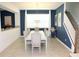 Dining room with large table and blue accent wall at 1864 Caribbean View Ter, Kissimmee, FL 34747