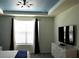 Bedroom with large window, TV, and dresser at 1864 Caribbean View Ter, Kissimmee, FL 34747