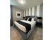 Bedroom with king-size bed and gray accent wall at 1864 Caribbean View Ter, Kissimmee, FL 34747