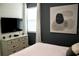 Bedroom with a dresser, TV, and large window at 1864 Caribbean View Ter, Kissimmee, FL 34747