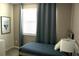 Small bedroom with a single bed and window at 1864 Caribbean View Ter, Kissimmee, FL 34747