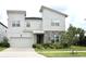 Two-story modern home with stone accents and a landscaped front yard at 1864 Caribbean View Ter, Kissimmee, FL 34747