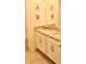 Double vanity bathroom with white cabinets and neutral tile at 1864 Caribbean View Ter, Kissimmee, FL 34747