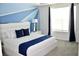 Spacious bedroom with blue and white decor at 1864 Caribbean View Ter, Kissimmee, FL 34747