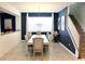 Spacious dining room with large table, chandelier, and blue accent wall at 1864 Caribbean View Ter, Kissimmee, FL 34747