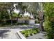 Landscaped home exterior with a gray paver driveway and lush greenery at 11130 Park Ave, Windermere, FL 34786