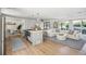 Open concept kitchen and living area with a large island and light wood floors at 11130 Park Ave, Windermere, FL 34786