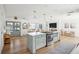 Open concept kitchen with island, stainless steel appliances, and light cabinets at 11130 Park Ave, Windermere, FL 34786