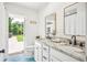 Modern bathroom boasts double vanity, walk-in shower, and backyard access at 11130 Park Ave, Windermere, FL 34786