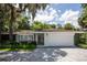 White house with gray paver driveway, landscaping, and a two-car garage at 11130 Park Ave, Windermere, FL 34786