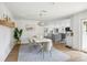 Open concept dining room with a white table and view of the kitchen at 11130 Park Ave, Windermere, FL 34786