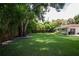 Large backyard with mature trees and a wooden fence at 11130 Park Ave, Windermere, FL 34786