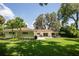 Large backyard with green lawn and a white house at 11130 Park Ave, Windermere, FL 34786