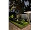 Landscaped front yard with boxwood hedges and lighting at 11130 Park Ave, Windermere, FL 34786