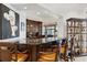 Home bar with dark wood cabinets and granite countertop at 11261 Macaw Ct, Windermere, FL 34786