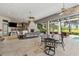 Expansive outdoor area with dining, seating, and fireplace at 11261 Macaw Ct, Windermere, FL 34786