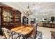 Bright dining room with a large table and view into living room at 11261 Macaw Ct, Windermere, FL 34786