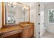Bathroom with granite countertop, single sink, and access to other rooms at 11261 Macaw Ct, Windermere, FL 34786