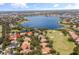 Stunning aerial view of a lakefront property in a golf course community at 11261 Macaw Ct, Windermere, FL 34786