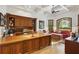 Spacious home office with built-in wooden cabinets and a large desk at 11261 Macaw Ct, Windermere, FL 34786