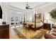 Luxurious main bedroom with stunning pool views and sitting area at 11261 Macaw Ct, Windermere, FL 34786