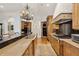 Gourmet kitchen features granite counters, island, and wood cabinetry at 11261 Macaw Ct, Windermere, FL 34786