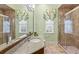 Bathroom with granite countertop, dual sinks, and a large glass shower at 11261 Macaw Ct, Windermere, FL 34786